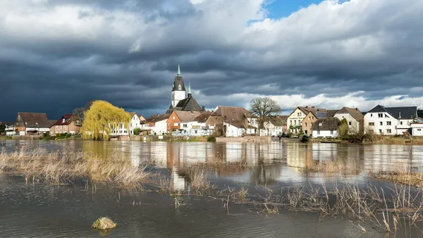 A flooded village beside a church