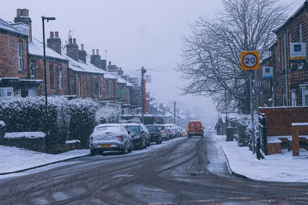 A street of terraced houses in snow