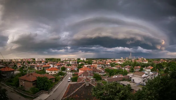 A storm front rolling over a town